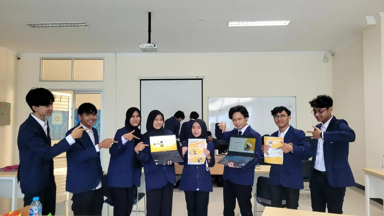 The Justipin team holding laptops and flyers that show the app.
